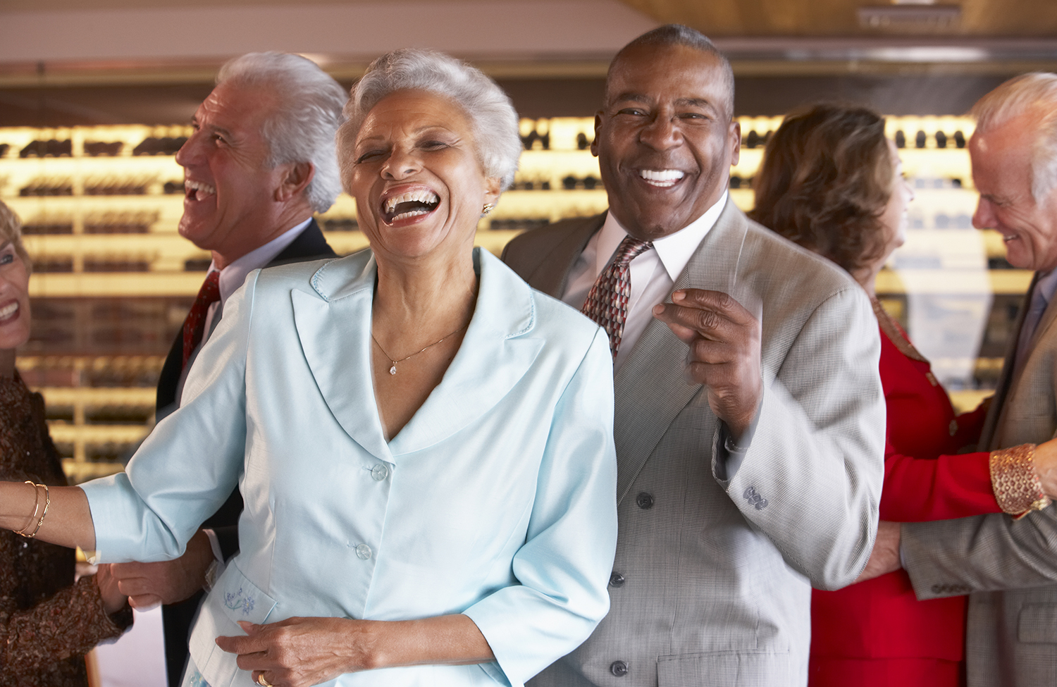 Photo of Couples Dancing Together including a laughing, smiling African American couple at center.