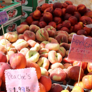 Farmers market display of assorted fresh fruits.