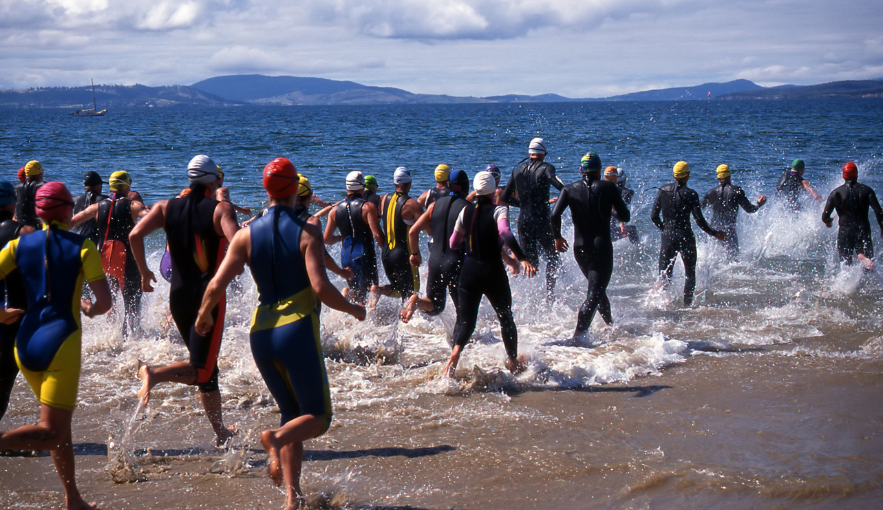 Competitors in Triathlon entering the water for the swimming leg.