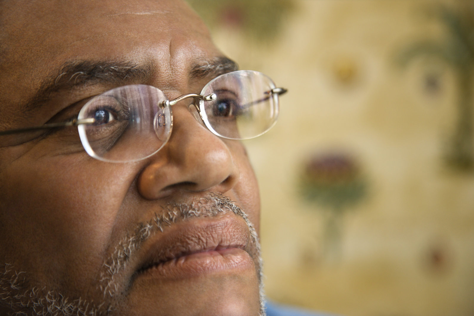 Portrait of senior black man in eyeglasses with serious expression. Horizontal shot.