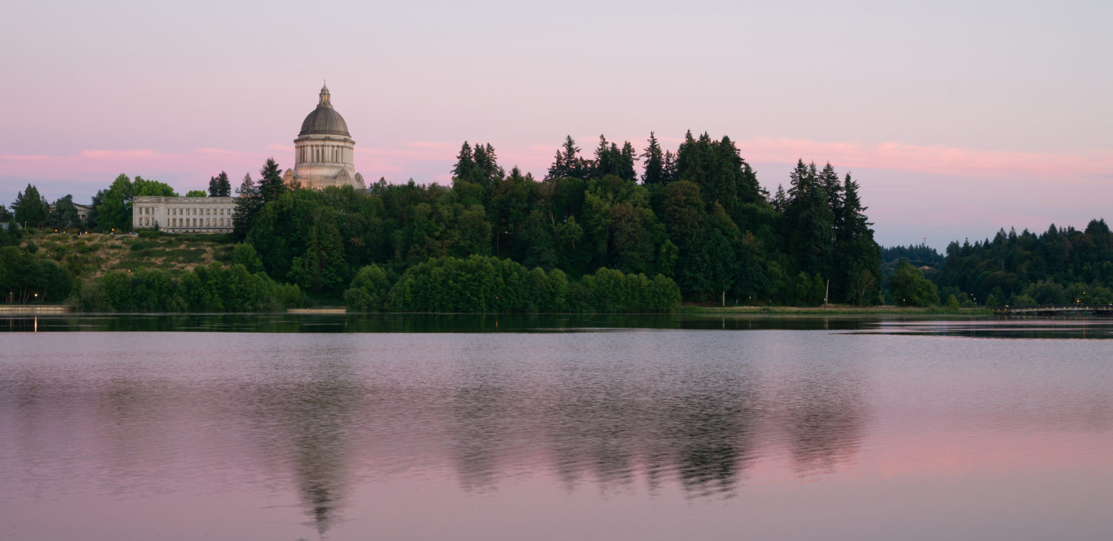 The state capital reflects in the lake of the same name at dusk in Olympia, Washington.