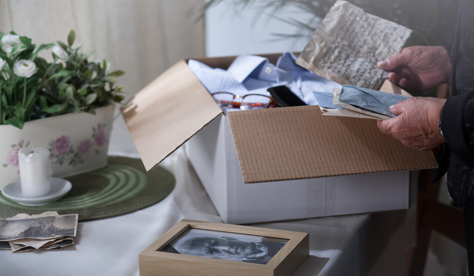 packing remembrances in a cardboard box