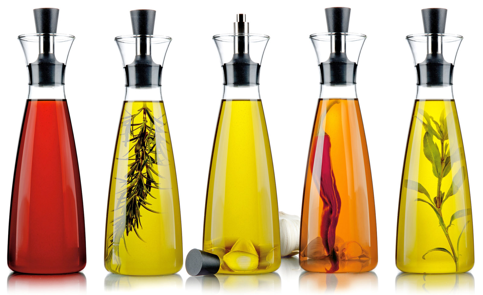 a row of five vinegar bottles, each with a different color or herbal content