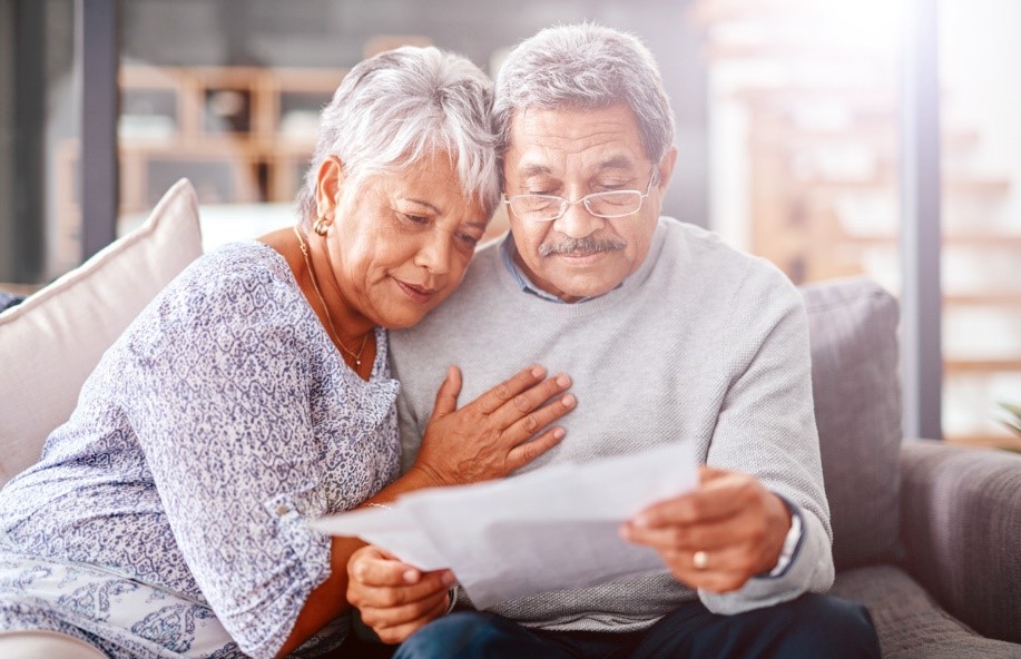 Older Latino couple look at paperwork