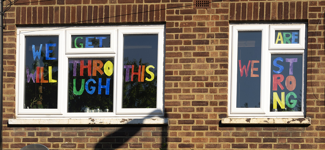 brick building with andpainted messages of hope in the windows