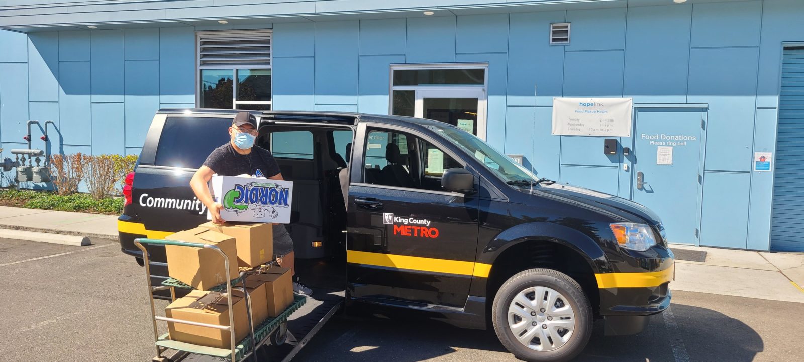 Paulo Medina, a Community Van volunteer drivers, lends a helping hand to deliver food boxes from the Shoreline Hopelink food bank.