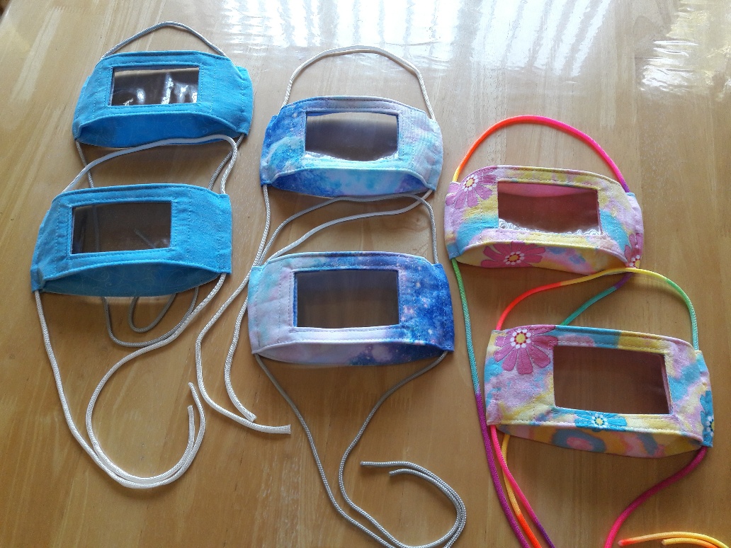 Six face masks with clear plastic windows so mouths show