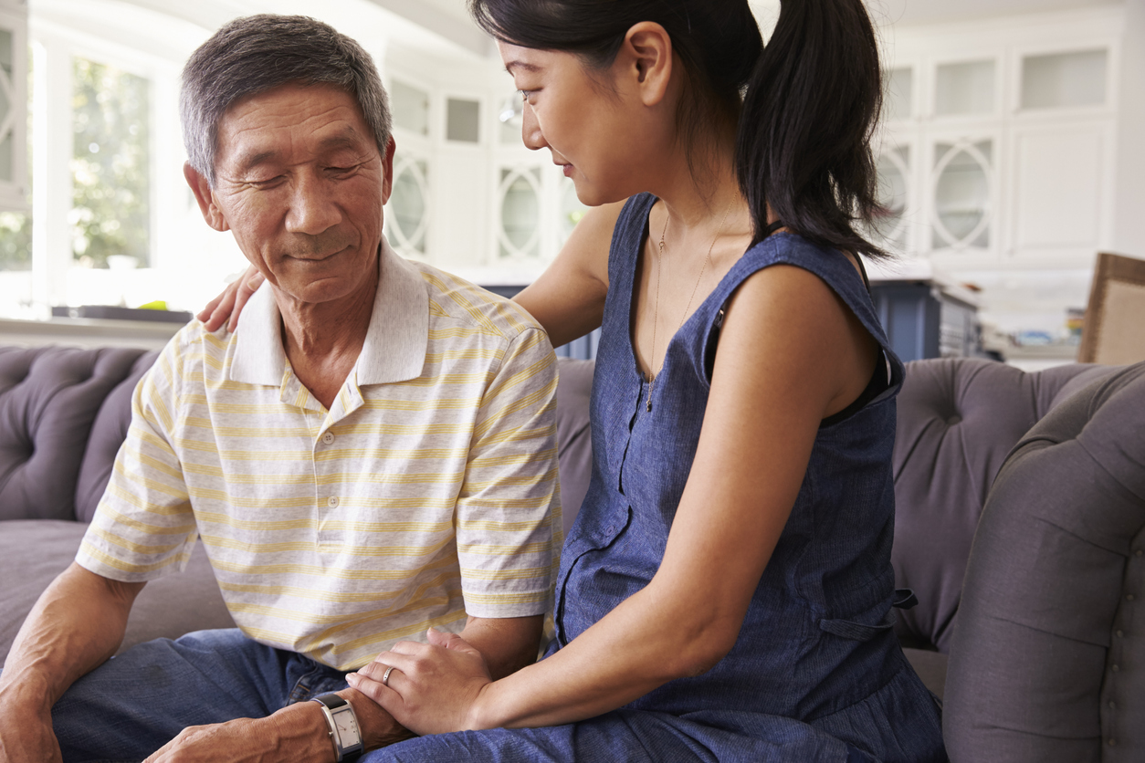 Young Asian woman talking with her father with care and concern