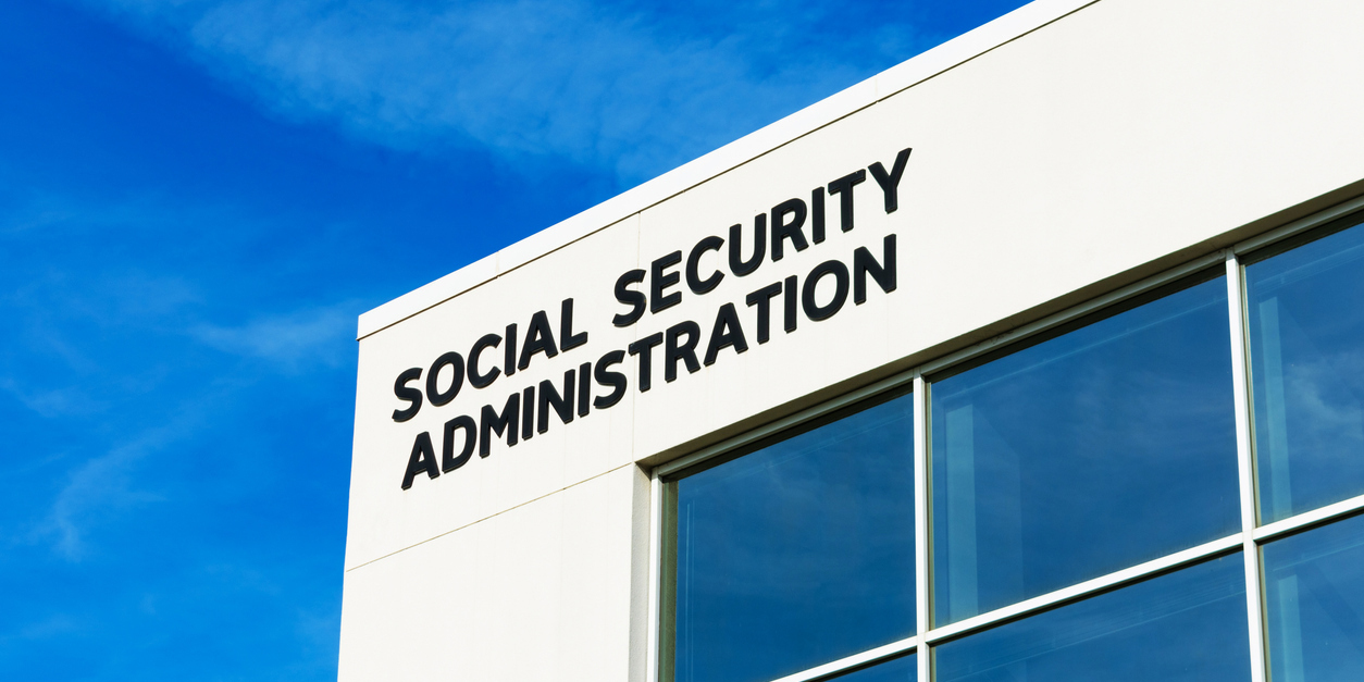 exterior corner of a Social Security Administration building with a blue sky in the background