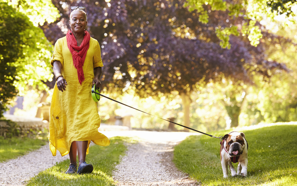 woman walking her dog in a park