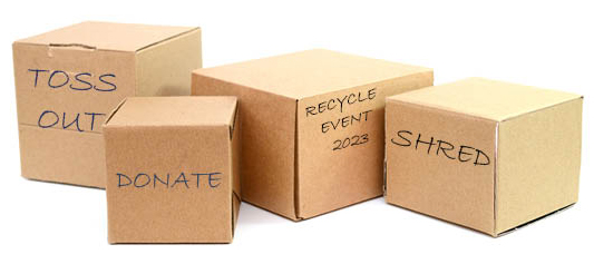 cardboard boxes labelled for recycle, donation, etc.