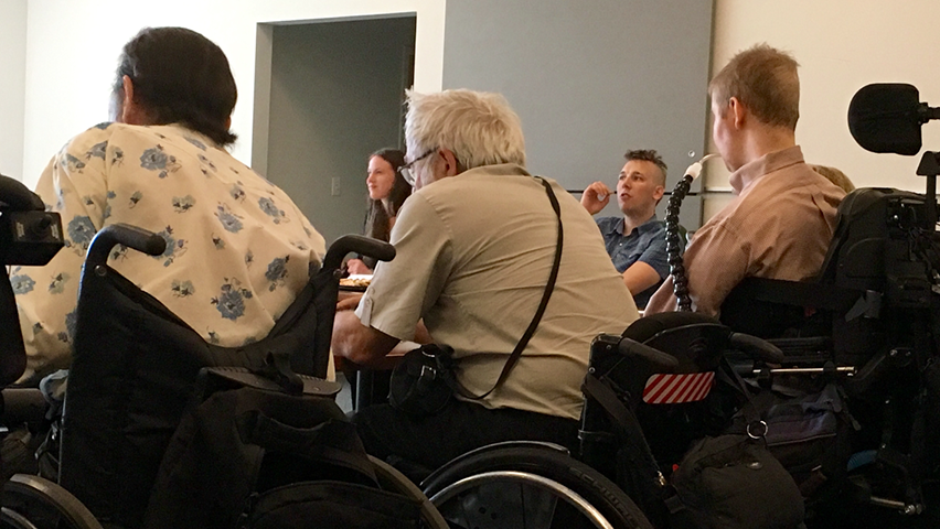 A 2017 meeting of the Seattle Disabilities Commission with 3 members who use wheelchairs in the foreground