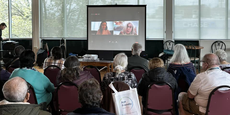Audience at Age Friendly Seattle Civic Coffee in May 2023, looking at projection screen with online presenters