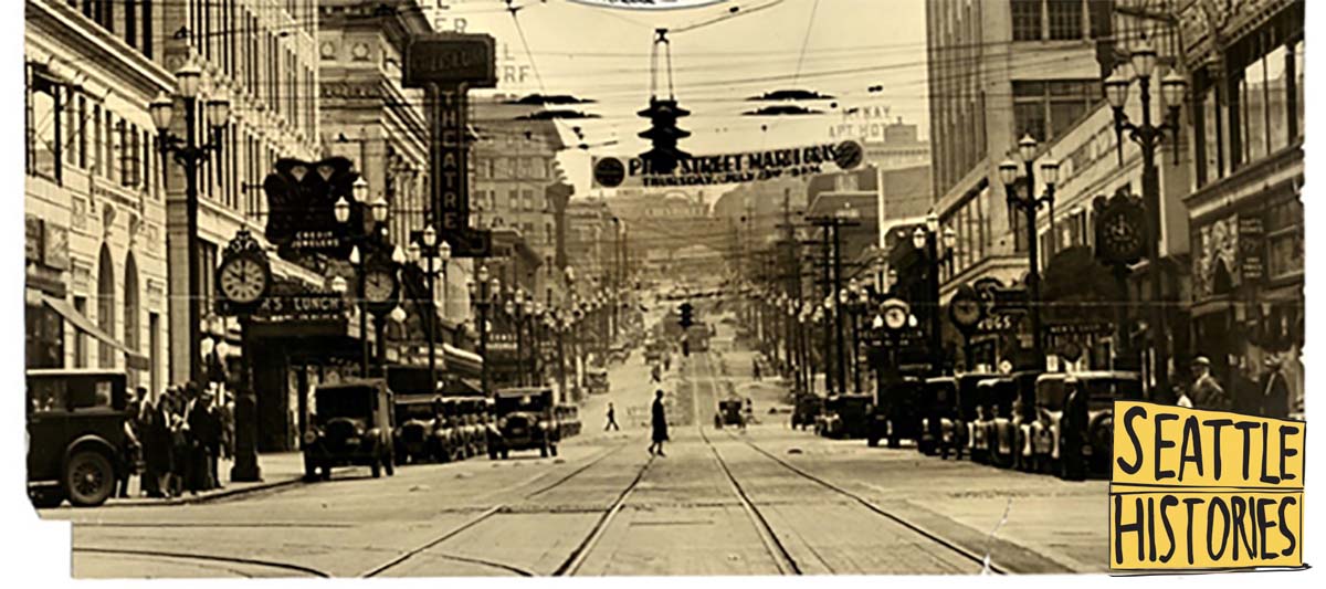historic photo of downtown Seattle shows at least three tall street clocks