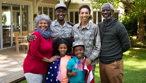 multi-generational African American family that includes two members wearing military fatigues